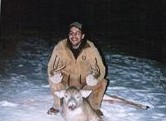 hunter holding a deer by the antlers