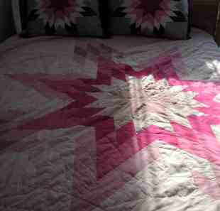 pink star quilt in the shadows