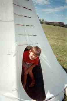 Child at Crow reservation in tipi